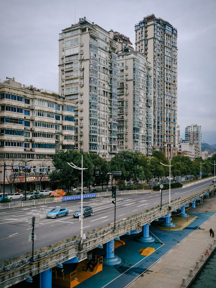 Urban cityscape showcasing high-rise buildings alongside a bustling elevated road.